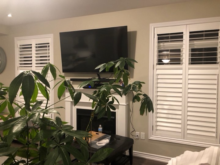 White shutters on both sides of a fireplace