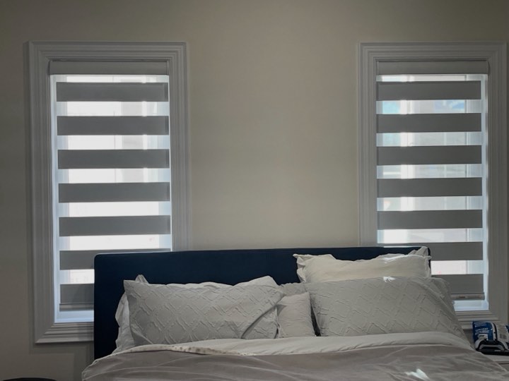 Grey zebra shades on a pair of bedroom windows