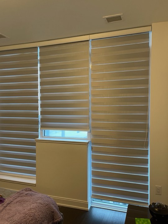 Floor-to-ceiling zebra shades in a bedroom
