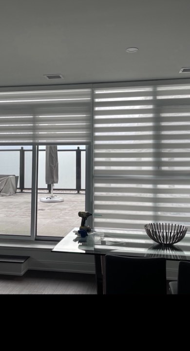 Zebra shades across a condo window wall